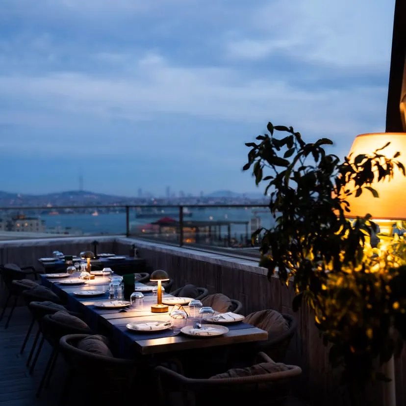 Candlelit tables on the Moise Karaköy terrace at dusk