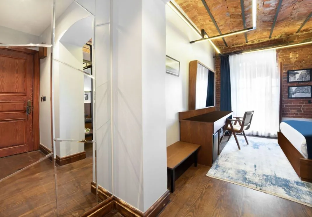 House Building guest room entrance and desk