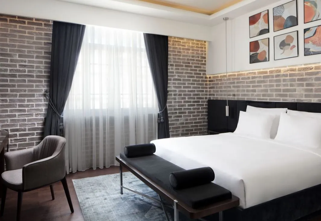 Banque Building guest room with grey brick walls
