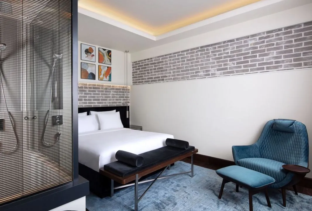 Banque Building guest room with a blue armchair