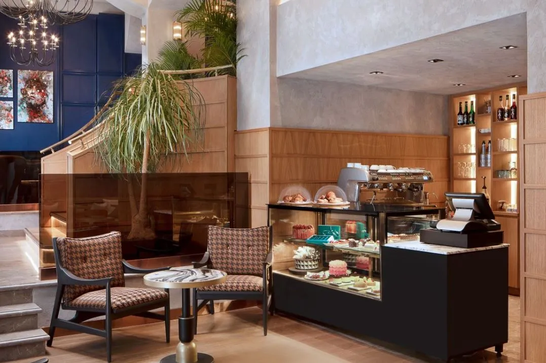 Coffee counter with pastries and armchairs