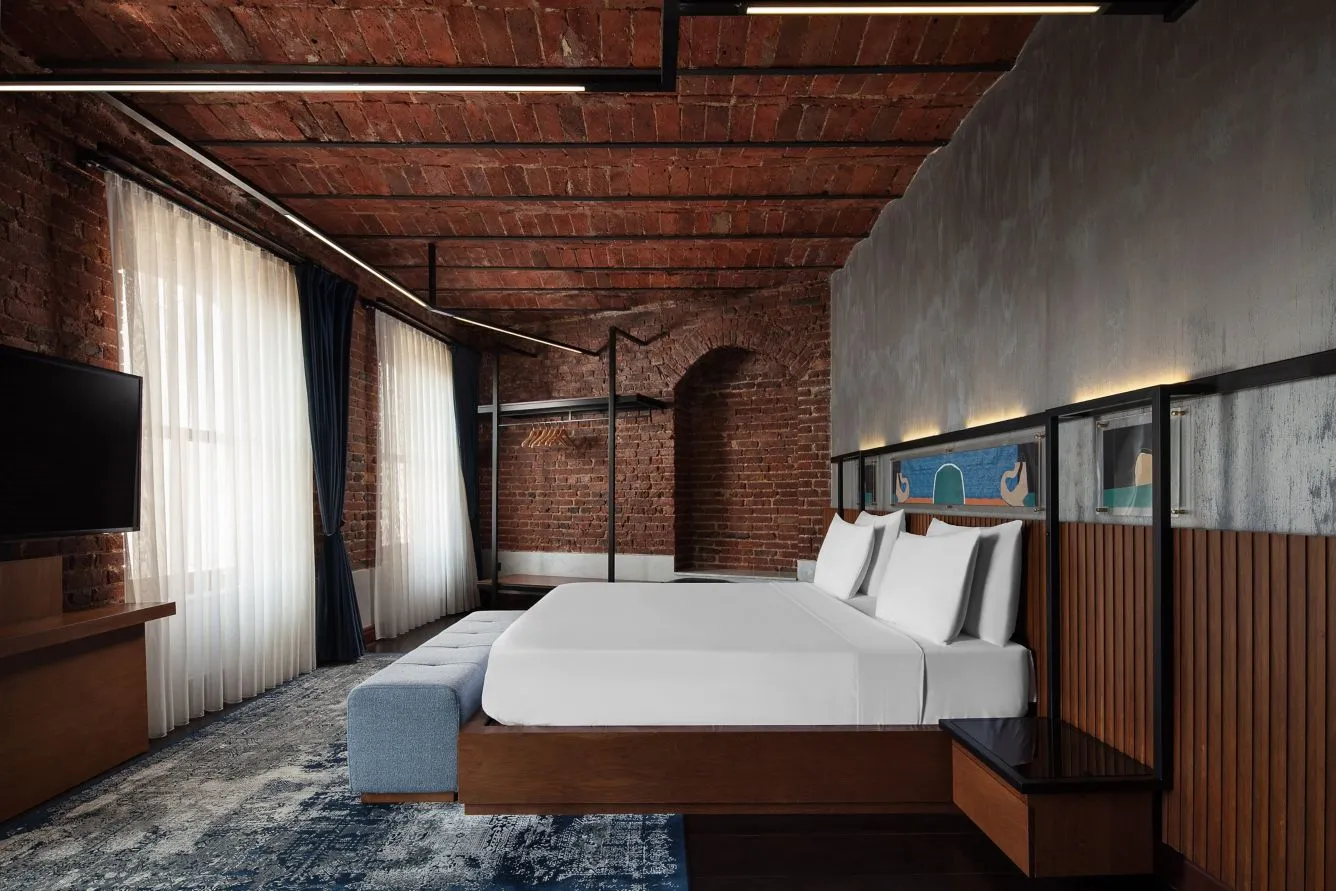 Galata House Suite bedroom with a King bed under a vaulted brick ceiling