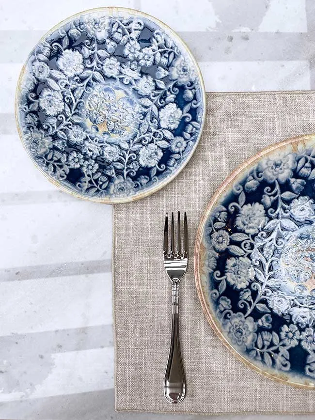 Blue-and-white patterned plates on a linen table