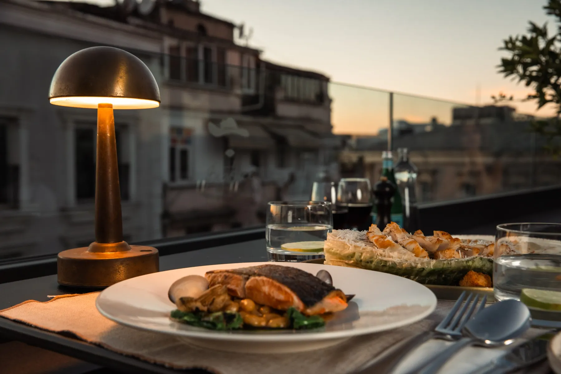 Plated dish by a table lamp on the terrace