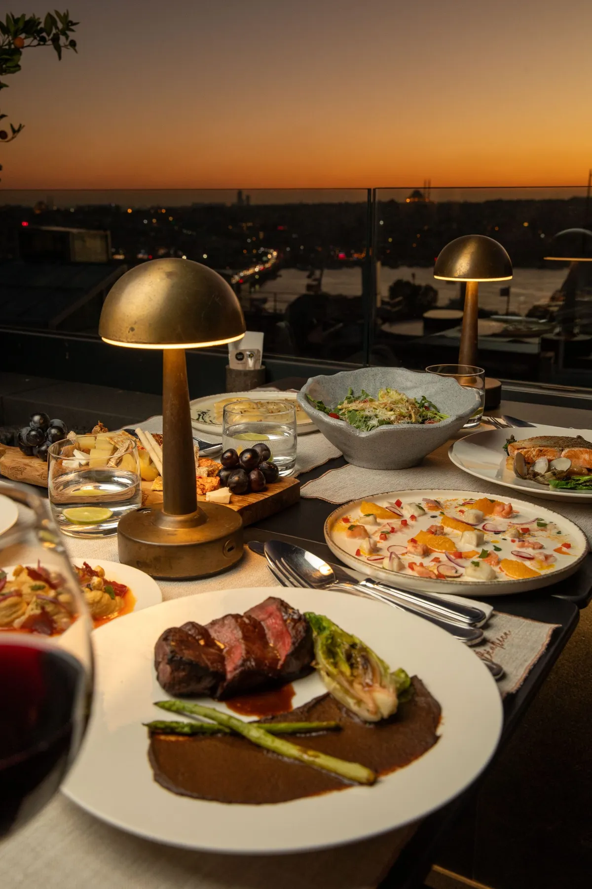 Steak and shared plates on the Béatrice terrace at sunset