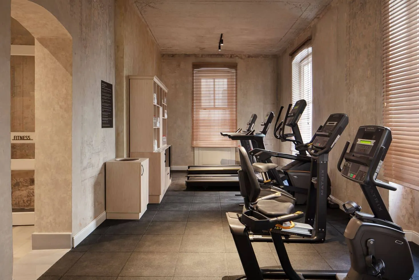 Hotel gym with cardio machines under arched ceilings