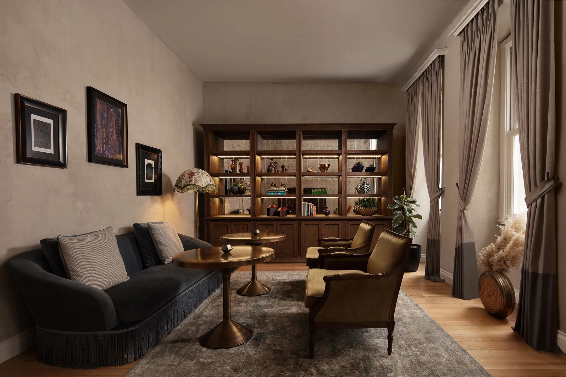 Lounge with a sofa, armchairs and bookshelves